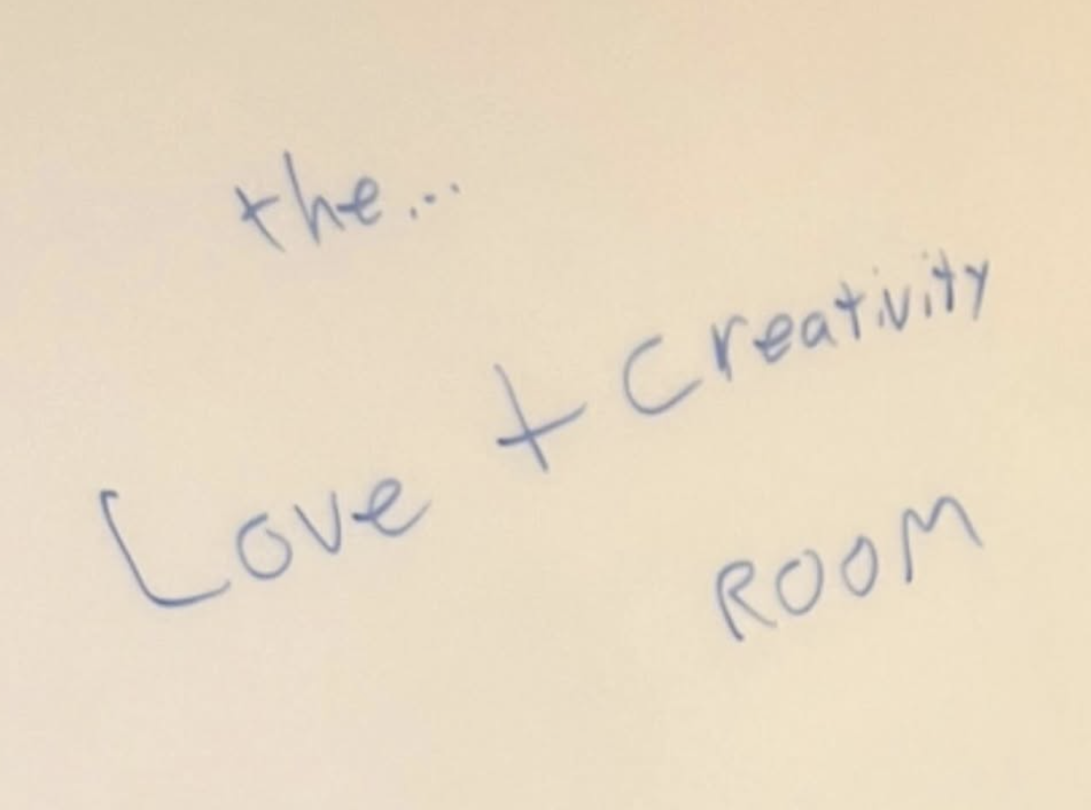 Handwritten note reading the Love + Creativity Room